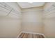 Walk-in closet with built-in wire shelving and wood-look flooring for optimal storage at 6255 W Arby Ave # 258, Las Vegas, NV 89118