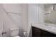 White bathroom featuring modern fixtures and a dark vanity at 6288 Dolosonte St, Las Vegas, NV 89113