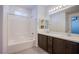 Stylish bathroom features double sinks, a bathtub with shower, and modern fixtures at 6288 Dolosonte St, Las Vegas, NV 89113