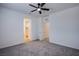 This carpeted bedroom has a ceiling fan and includes a walk-in closet just to the left of the room at 6288 Dolosonte St, Las Vegas, NV 89113