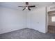 The carpeted bedroom features a closet with sliding doors and a ceiling fan, and overlooks other rooms at 6288 Dolosonte St, Las Vegas, NV 89113