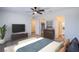 Bright bedroom features ceiling fan, en suite bathroom, and a closet with plenty of storage space at 6288 Dolosonte St, Las Vegas, NV 89113