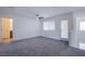 This bedroom is spacious, has a ceiling fan, and access to a private balcony and bathroom at 6288 Dolosonte St, Las Vegas, NV 89113
