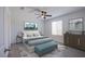 Bright bedroom with cool color accents, ceiling fan, and modern decor at 6288 Dolosonte St, Las Vegas, NV 89113