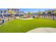 Community dog park featuring an artificial turf play area, bench seating, and secure fencing for pet enjoyment at 6288 Dolosonte St, Las Vegas, NV 89113
