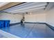 Spacious garage with an epoxy floor, storage shelves and an automatic garage door opener at 6288 Dolosonte St, Las Vegas, NV 89113