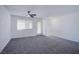 A versatile living space with a ceiling fan and access to the balcony at 6288 Dolosonte St, Las Vegas, NV 89113