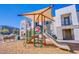 Community playground with a sunshade structure, slide, climbing features, and benches, perfect for outdoor play at 6288 Dolosonte St, Las Vegas, NV 89113