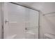 White shower with glass doors and built-in bench at 6288 Dolosonte St, Las Vegas, NV 89113