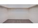 Empty walk-in closet with wood rods and carpet at 6288 Dolosonte St, Las Vegas, NV 89113