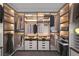 This walk-in closet has custom shelving, drawers, and LED lighting at 6288 Dolosonte St, Las Vegas, NV 89113