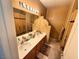 Bathroom features a double sink, warm-toned walls, and decorative fixtures at 6351 Davidson Ct, Las Vegas, NV 89110