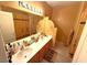 Bathroom features a double sink, warm-toned walls, and decorative fixtures at 6351 Davidson Ct, Las Vegas, NV 89110