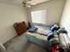 Inviting bedroom with plush carpeting and ceiling fan at 6351 Davidson Ct, Las Vegas, NV 89110