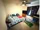 Cozy bedroom featuring a ceiling fan, tv, and an eclectic mix of decorations at 6351 Davidson Ct, Las Vegas, NV 89110
