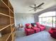 Bonus room featuring a large window, a ceiling fan, and a large sofa at 6351 Davidson Ct, Las Vegas, NV 89110