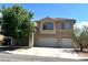 Two-story home with a two-car garage and tile roof, complemented by mature landscaping at 6351 Davidson Ct, Las Vegas, NV 89110
