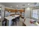 Open kitchen with island and seating, alongside a cozy breakfast nook with a ceiling fan at 6351 Davidson Ct, Las Vegas, NV 89110
