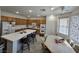 Open kitchen featuring an island with barstools and a dining area at 6351 Davidson Ct, Las Vegas, NV 89110