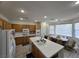 Bright kitchen showcasing an island with seating and a dining area by large windows at 6351 Davidson Ct, Las Vegas, NV 89110