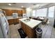 Spacious kitchen featuring a large island with tile countertops and a bright breakfast nook at 6351 Davidson Ct, Las Vegas, NV 89110