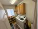 Laundry room features a washer, dryer, storage cabinets, and a bright window at 6351 Davidson Ct, Las Vegas, NV 89110