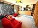 Comfortable living room with large windows, built-in shelves, and red reclining seats at 6351 Davidson Ct, Las Vegas, NV 89110