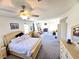 Spacious main bedroom with a ceiling fan, fireplace, sitting area, and carpeted flooring at 6351 Davidson Ct, Las Vegas, NV 89110
