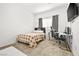 Neutral bedroom features a window, carpet, and gamer desk space with natural light at 6425 Classic Ridge St, North Las Vegas, NV 89086