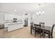 Open floor plan showcasing kitchen, dining area, and staircase, creating a seamless flow for modern living at 6425 Classic Ridge St, North Las Vegas, NV 89086