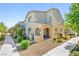 Inviting two-story home features a charming facade, manicured landscaping, and a welcoming entryway for great curb appeal at 6425 Classic Ridge St, North Las Vegas, NV 89086