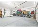 Spacious garage with epoxy floor, storage racks, and ample space for vehicles and hobbies at 6425 Classic Ridge St, North Las Vegas, NV 89086