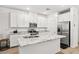 Modern kitchen featuring granite countertops, stainless steel appliances, and an island with a breakfast bar at 6425 Classic Ridge St, North Las Vegas, NV 89086