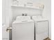 Practical laundry room equipped with a washer, a dryer, and a convenient storage shelf above at 6425 Classic Ridge St, North Las Vegas, NV 89086