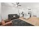Bright living room featuring a cozy sofa, modern decor, and an open layout connecting to the kitchen area at 6425 Classic Ridge St, North Las Vegas, NV 89086