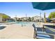 Resort-style community pool includes lounge chairs and umbrellas, creating a relaxing atmosphere at 6425 Classic Ridge St, North Las Vegas, NV 89086