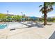 Community pool area featuring a pristine pool, inviting lounge chairs, and shaded umbrellas at 6425 Classic Ridge St, North Las Vegas, NV 89086