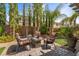 Outdoor patio featuring a fire pit with plush seating and mature desert landscaping at 6540 W Cougar Ave, Las Vegas, NV 89139