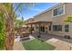 Backyard with covered patio, desert landscaping, and views of the two-story home at 6540 W Cougar Ave, Las Vegas, NV 89139