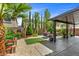 Landscaped backyard with a covered patio area, desert landscaping, and private setting at 6540 W Cougar Ave, Las Vegas, NV 89139