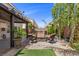 Cozy backyard with a fire pit and patio set, complete with mature landscaping and desert foliage at 6540 W Cougar Ave, Las Vegas, NV 89139