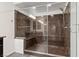 Modern bathroom featuring a glass-enclosed shower with a built-in seat and sleek fixtures at 6540 W Cougar Ave, Las Vegas, NV 89139