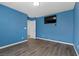 Spacious bedroom with plank flooring, window and modern fixtures at 6540 W Cougar Ave, Las Vegas, NV 89139