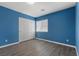 Inviting bedroom with plank flooring, a window, and a closet, perfect for relaxation at 6540 W Cougar Ave, Las Vegas, NV 89139