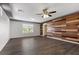 Inviting bedroom with wood accent wall, modern ceiling fan, and lots of light at 6540 W Cougar Ave, Las Vegas, NV 89139