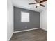 Well-lit bedroom featuring modern plank floors, a large window, and a ceiling fan at 6540 W Cougar Ave, Las Vegas, NV 89139