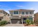 Two-story home featuring a well-manicured front yard and a two car garage at 6540 W Cougar Ave, Las Vegas, NV 89139