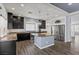 Stylish kitchen with granite countertops, stainless steel appliances, dark cabinetry, and an inviting kitchen island at 6540 W Cougar Ave, Las Vegas, NV 89139