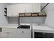 Laundry room with upper cabinets, gray tiled backsplash, countertop and newer washer and dryer machines at 6540 W Cougar Ave, Las Vegas, NV 89139
