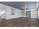 Large living room with hardwood floors, built in shelves and recessed lighting at 6540 W Cougar Ave, Las Vegas, NV 89139